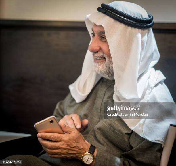 happy laughing mature arab man with kaffiyeh - old saudi man stock pictures, royalty-free photos & images
