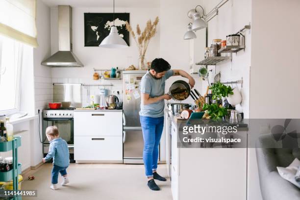 Asian man with his child making ramen soup at home