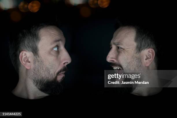 confused man against scared one - identical twins stockfoto's en -beelden