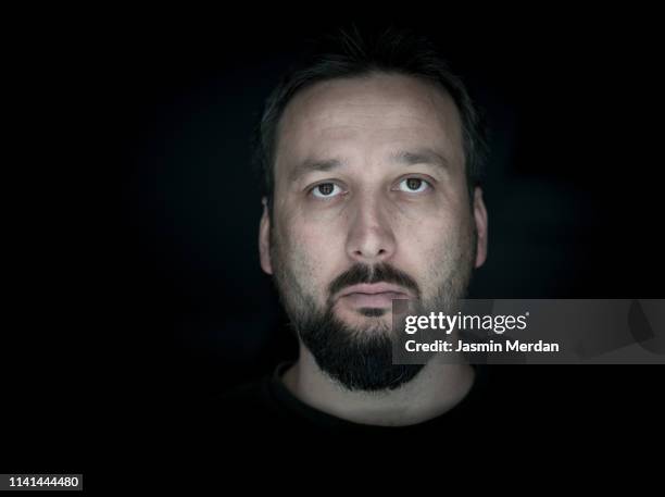 adult man on black background - portrait dark background stock pictures, royalty-free photos & images