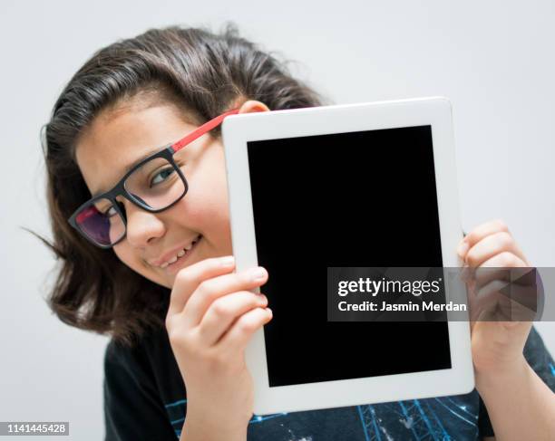 child with tablet in hands - kid presenting stock pictures, royalty-free photos & images