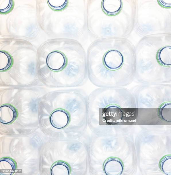 group of crumpled plastic drink water bottles for recycling with recycling word - komposition stock-fotos und bilder