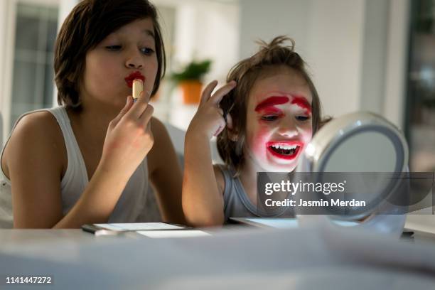 two brothers playing with lipstick on mirror - kids makeup stock pictures, royalty-free photos & images
