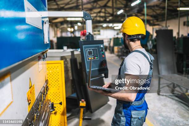 man working at a factory - 2000 technology stock pictures, royalty-free photos & images