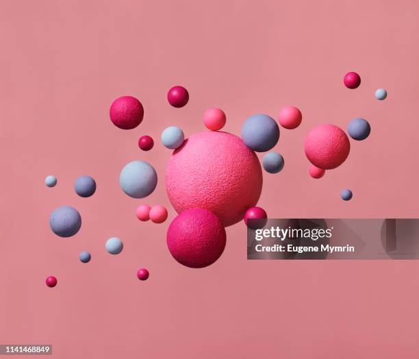 abstract multi-colored spheres on pink background - color intensity stock-fotos und bilder