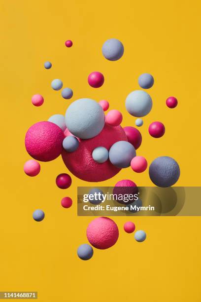 abstract multi-colored spheres on yellow background - intensidade de cores imagens e fotografias de stock