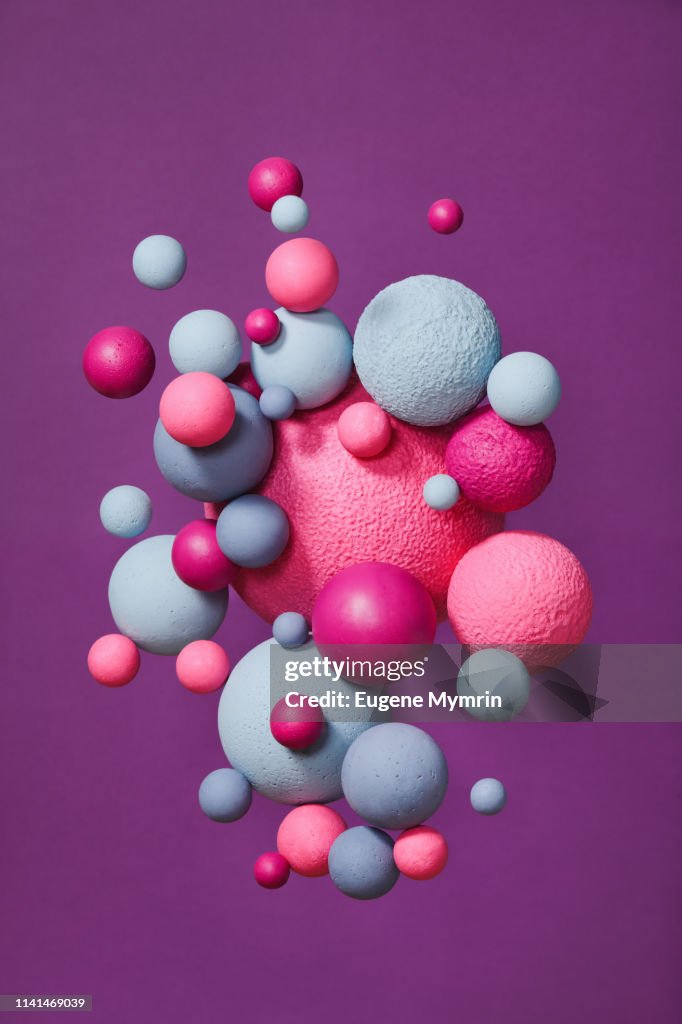 Abstract multi-colored spheres on purple background