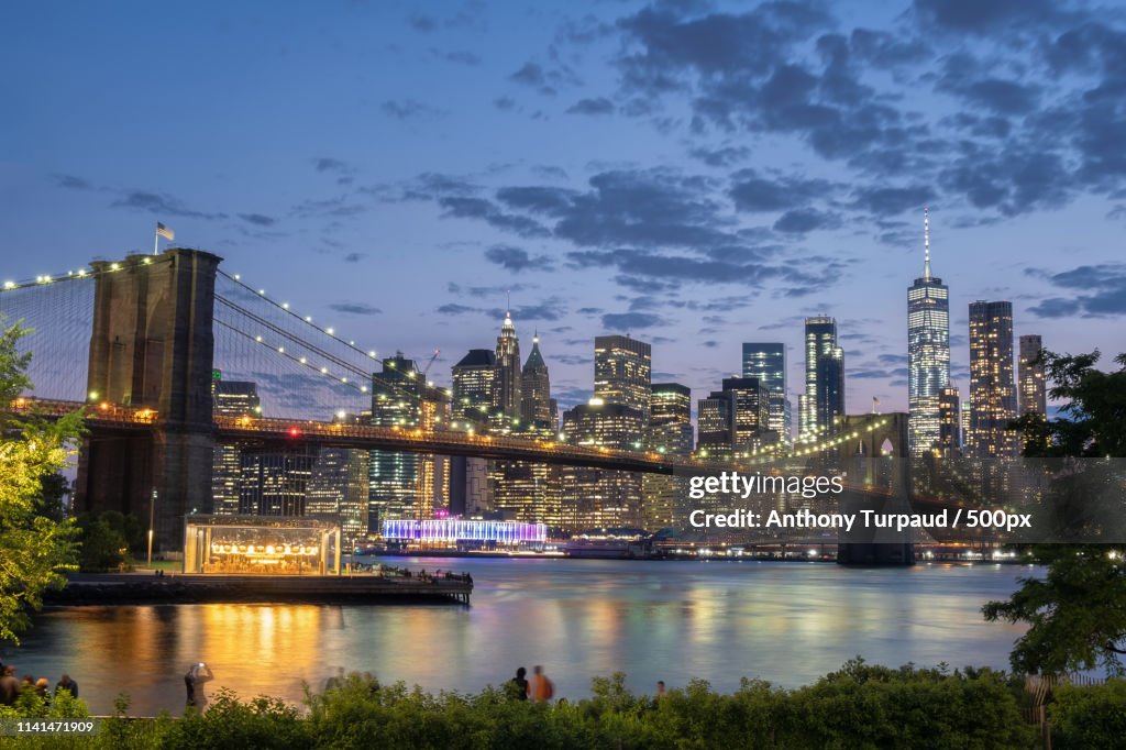 City Landscape With Bridge In Front At Dusk High-Res Stock Photo ...