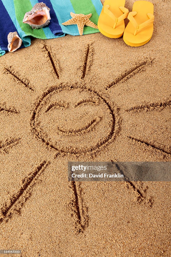 Beach scene with smiling sun