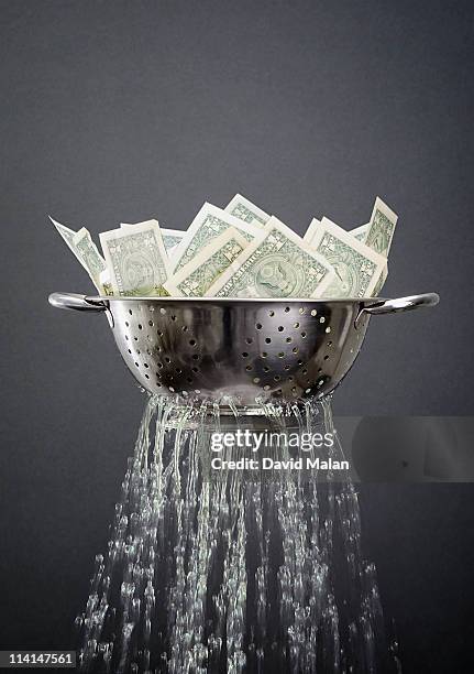 a draining colander full of money - colander stockfoto's en -beelden