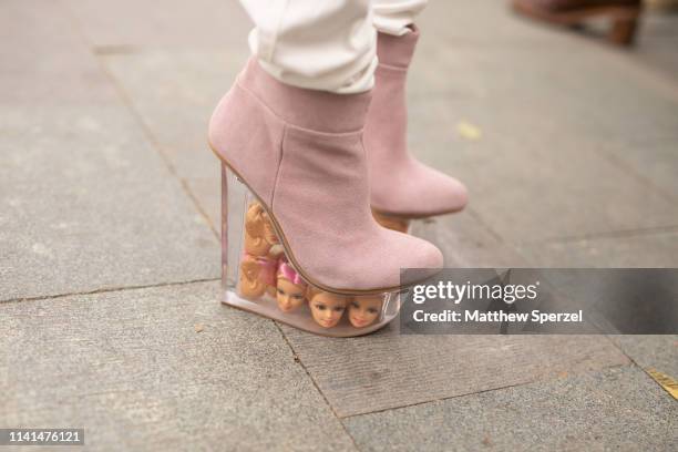 Guest is seen on the street attending Shanghai Fashion Week A/W 2019/2020 wearing pink suede platform shoes with plastic tank filled with Barbie doll...