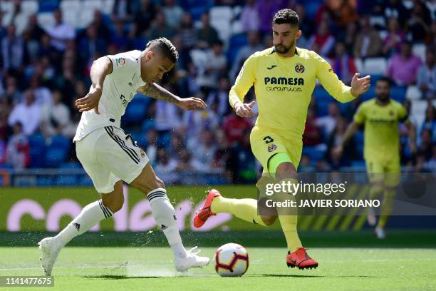 Real Madrid's Spanish-Dominican forward Mariano shoots beside Villarreal's Spanish defender Alvaro Gonzalez to score the opening goal during the...