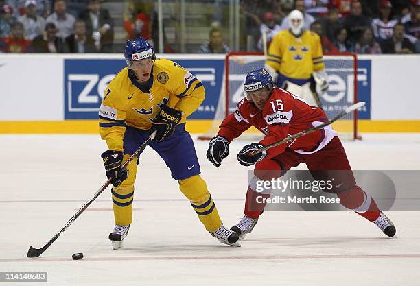 Jan Marek of Czech Republic and David Rundbald of Sweden battle for the puck during the IIHF World Championship semi final match between Czech...