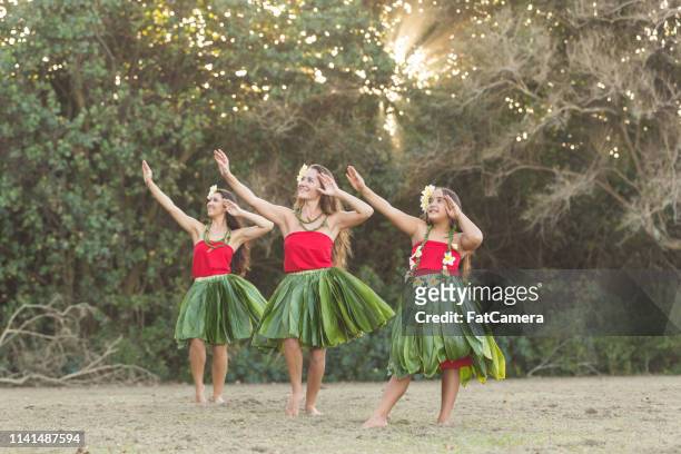 three hula dancers performing outside - hula dancing stock pictures, royalty-free photos & images