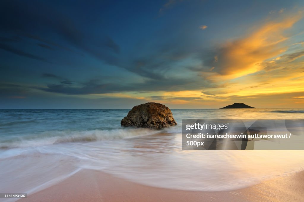 View of sunset over sea and beach