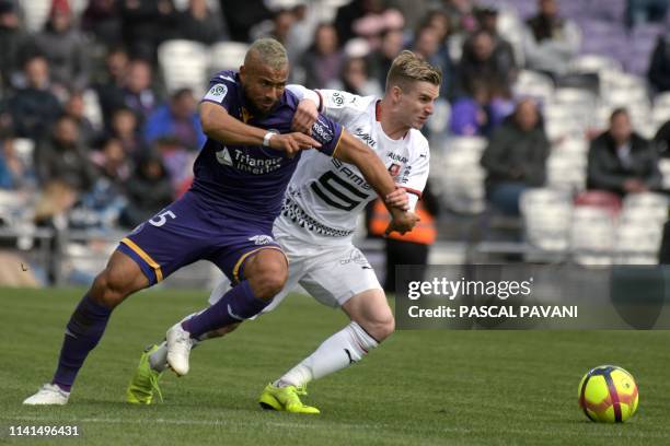 Toulouse's Trinidad midfielder John Bostock vies with Rennes French midfielder Benjamin Bourigeaud during the French L1 football match between...