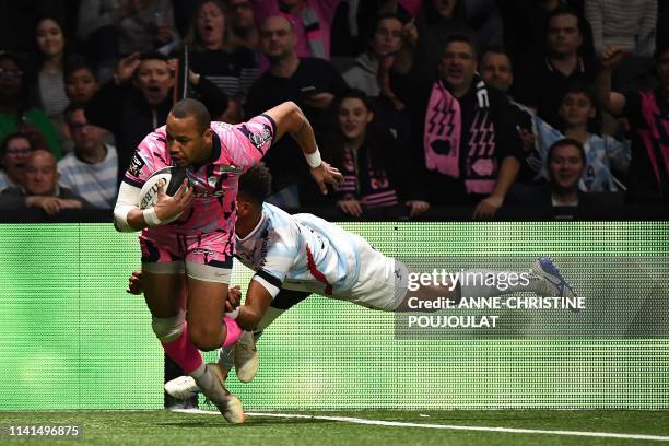 Stade Francais' French center Gael Fickou vies with Racing92's Fiji fly-half Ben Volavola before scoring a try during the French Top 14 rugby union...