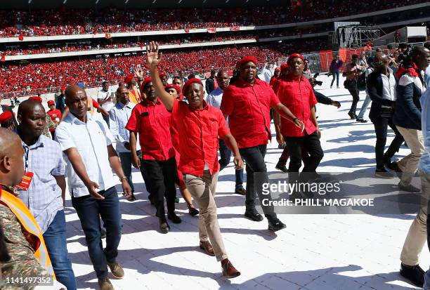 Opposition party Economic Freedom Fighters leader Julius Malema greets his supporters as he arrives for EFF final election rally at Orlando Stadium...