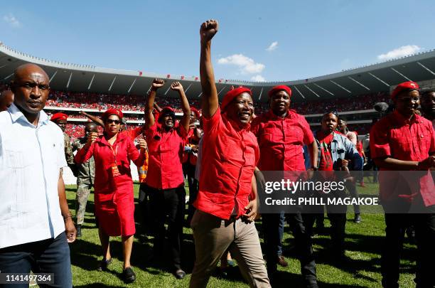 Opposition party Economic Freedom Fighters leader Julius Malema raises his fist as he arrives for EFF final election rally at Orlando Stadium in...