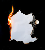 burning piece of  paper on black background