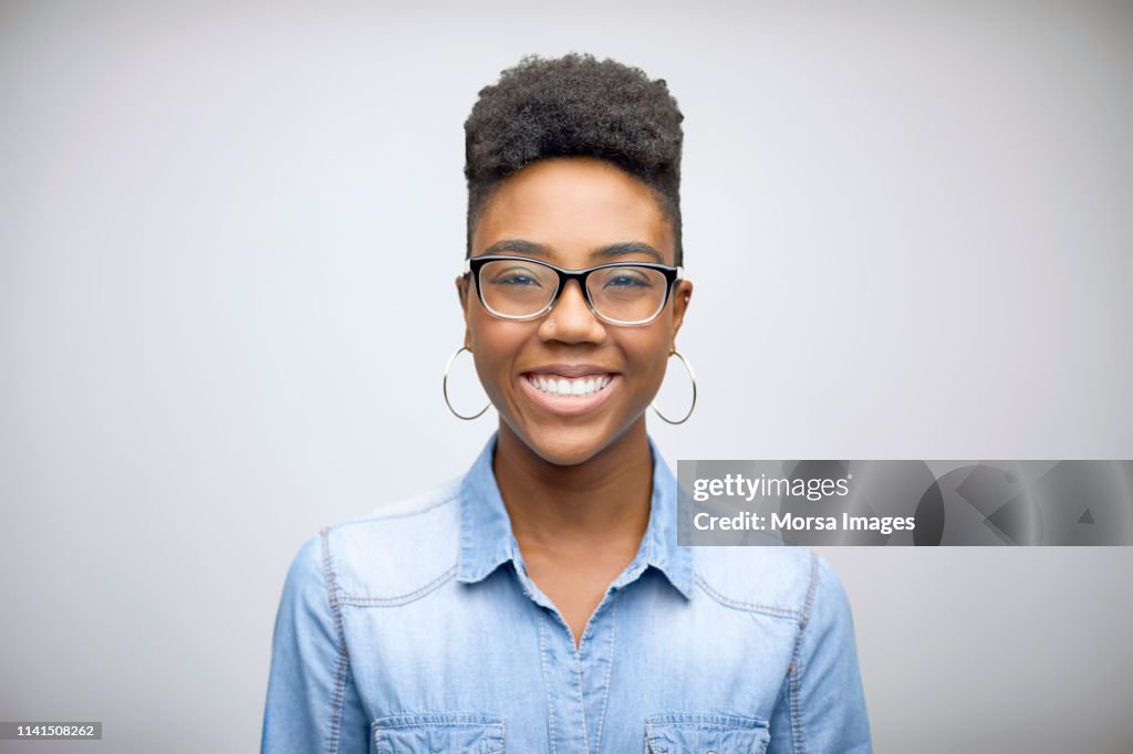 Smiling female afro owner against white background