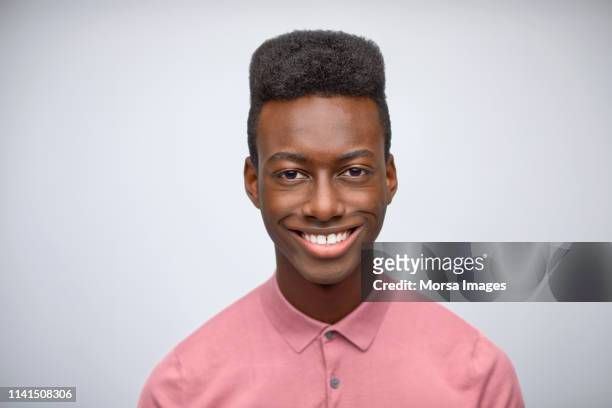 portrait of smiling young entrepreneur in studio - afro hairstyle stock-fotos und bilder