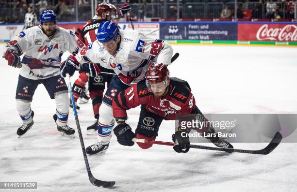 David Wolf of Mannheim challenges Moritz Mueller of Koeln during the fourth game of the DEL Play-Offs Semi Final between Koelner Haie and Adler...