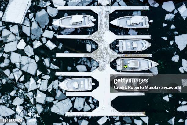 aerial view of boats in the icy sea, ballstad, norway - snow directly above stock pictures, royalty-free photos & images