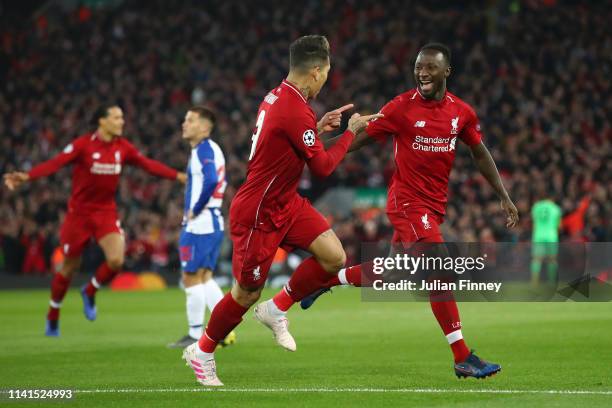 Naby Keita of Liverpool celebrates with teammate Roberto Firmino of Liverpafter scoring his team's first goal with Roberto Firmino of Liverpool...