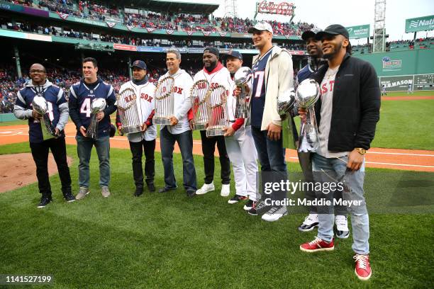 Matthew Slater, Joe Cardona, Manny Ramirez, Mike Lowell, David Ortiz, Steve Pearce, Rob Gronkowski, Duron Harmon, and Patrick Chung pose for photos...