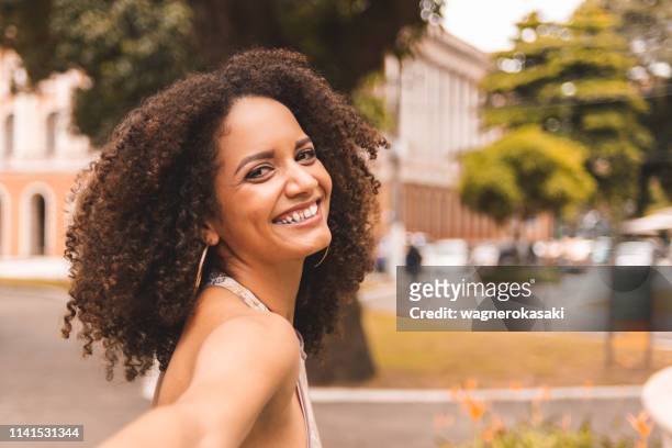 follow me pov of young brazilian woman smiling and holding hands - para state stock pictures, royalty-free photos & images