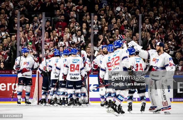 Players of Mannheim celebrate after winning the fourth game of the DEL Play-Offs Semi Final between Koelner Haie and Adler Mannheim at Lanxess Arena...