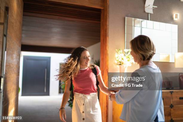 granddaughter visiting grandmother - teen arriving home stock pictures, royalty-free photos & images