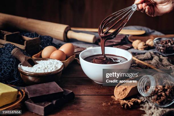 making chocolate mousse on a wooden table in a rustic kitchen - chocolate mousse stock pictures, royalty-free photos & images