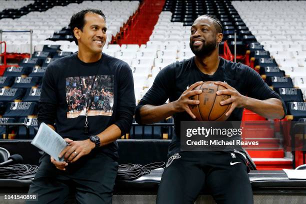 Dwyane Wade of the Miami Heat talks with head coach Erik Spoelstra prior to his final regular season home game of his career against the Philadelphia...