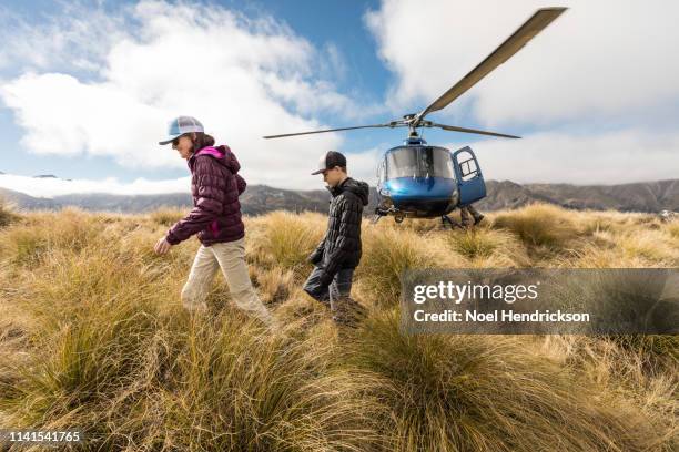 mother and son hiking the mountains of new zealand south island - helicopter parenting stock pictures, royalty-free photos & images