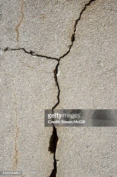 cracks in a concrete wall - broken concrete stock pictures, royalty-free photos & images