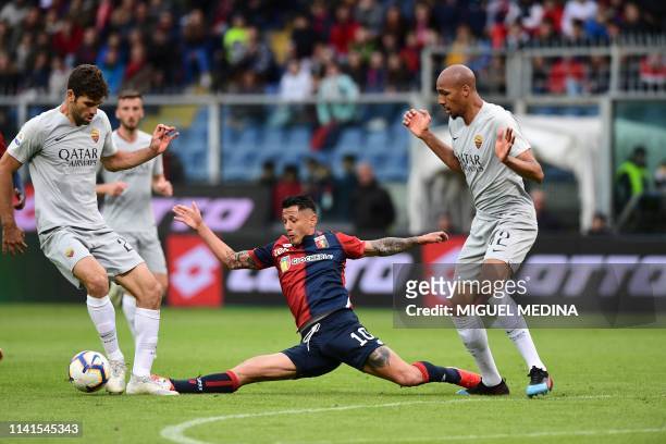 Genoa's Italian forward Gianluca Lapadula vies with AS Roma Argentine defender Federico Fazio and AS Roma French midfielder Steven Nzonzi during the...
