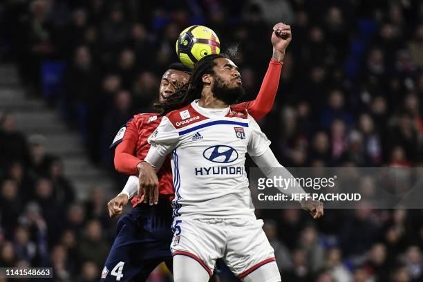 Lyon's Belgian defender Jason Denayer vies with Lille's Brazilian defender Gabriel Magalhaes during the French L1 football match between Olympique...