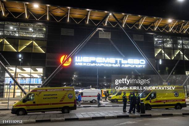 Ambulances are parked in front of the terminal building of the Sheremetyevo Airport outside Moscow after a Russian-made Superjet-100 on fire...