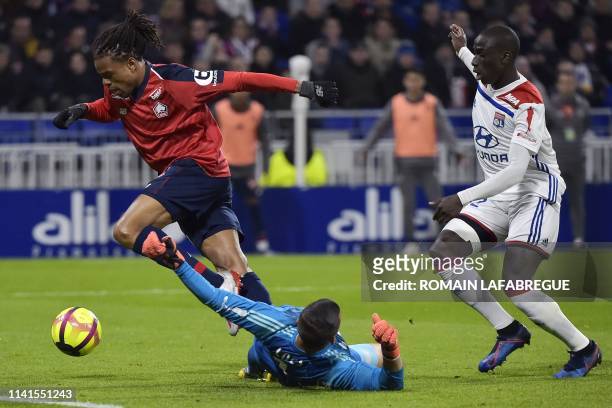 Lille's French forward Loic Remy vies with Lyon's Portuguese goalkeeper Anthony Lopes and Lyon's French defender Ferland Mendy before scoring a goal...