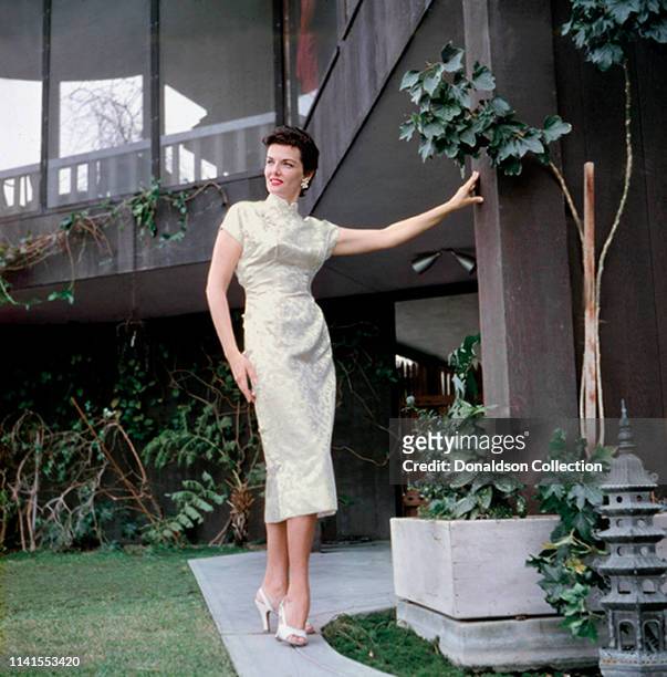 Actress Jane Russell at home in an evening gown in 1957.