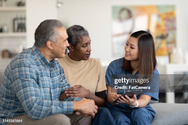 sharing results with an elderly couple - diabetes technology stock pictures, royalty-free photos & images