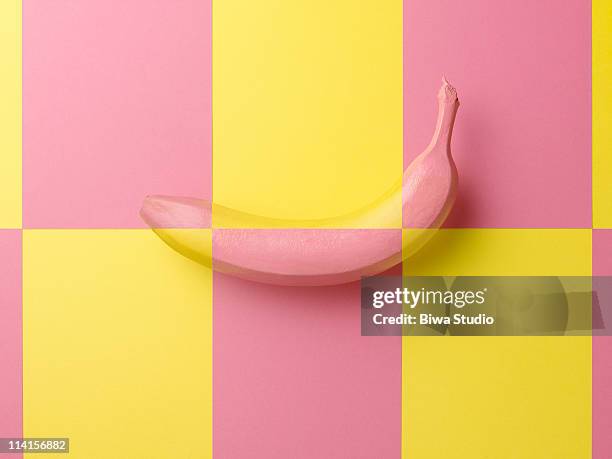 banana on yellow & pink background - creative images stock-fotos und bilder