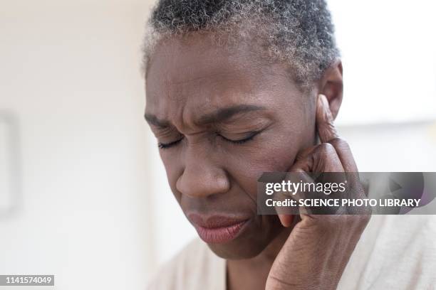 woman touching ear - woman fingers in ears stock pictures, royalty-free photos & images