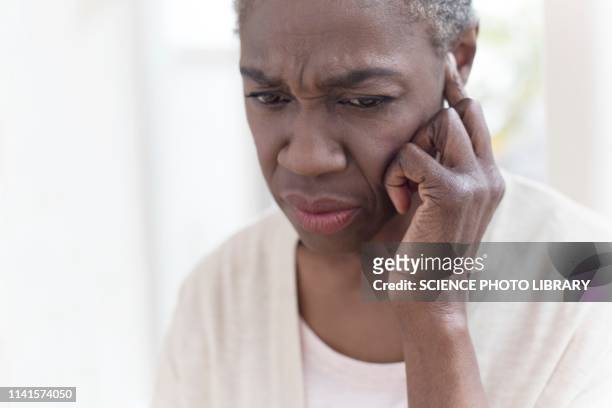 woman touching ear - woman fingers in ears stock pictures, royalty-free photos & images