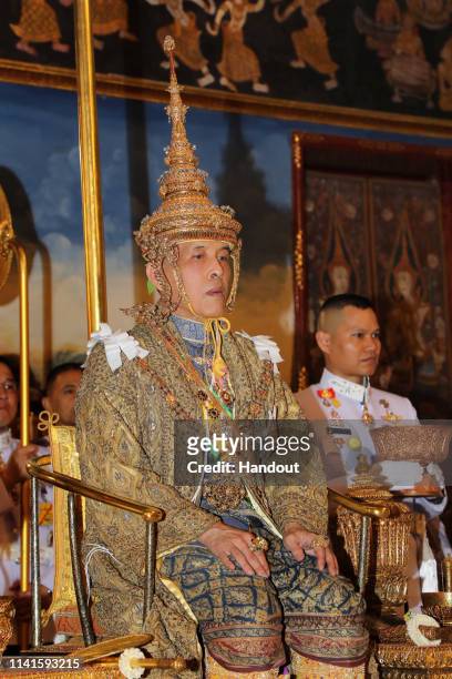 In this handout image provided by the Public Relations for the Coronation of King Rama X, Thai King Maha Vajiralongkorn and his wife, Queen Suthida,...