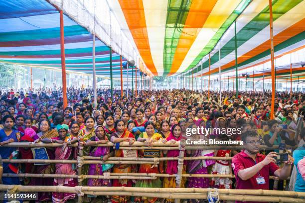 Supporters listen to West Benghal Chief Minister Mamata Banerjee, not pictured, during a campaign rally in Swarupnagar, West Bengal, India, on...