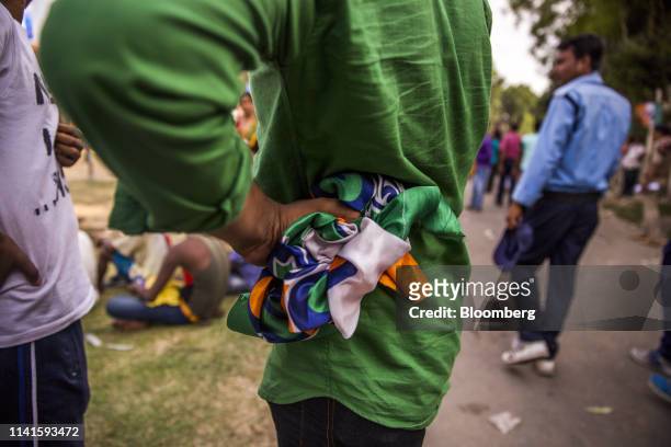 Man holds an All India Trinamool Congress party flag following a campaign rally with West Benghal Chief Minister Mamata Banerjee in Swarupnagar, West...