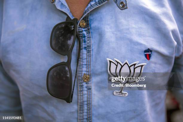 An attendee wears a Bharatiya Janata Party button during a campaign rally in Maslandapur, West Bengal, India, on Monday, April 29, 2019. West Bengal...